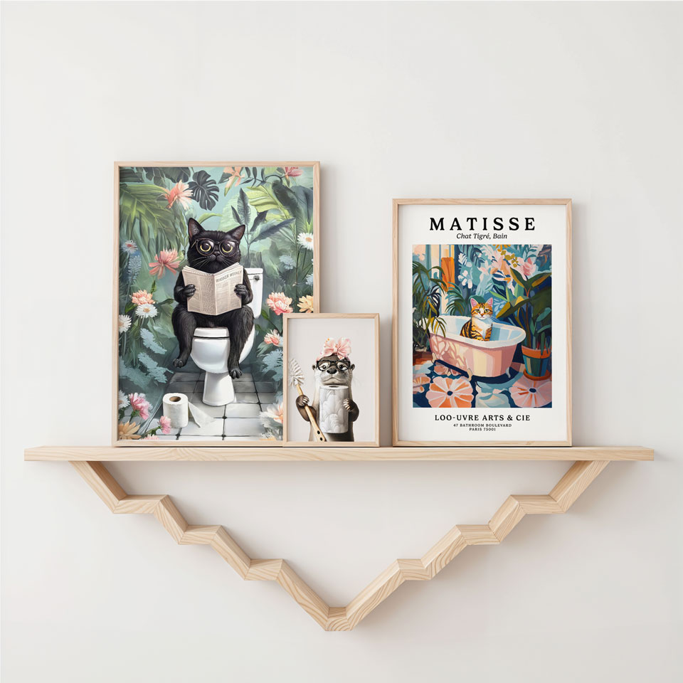 a couple of pictures on a shelf above a toilet