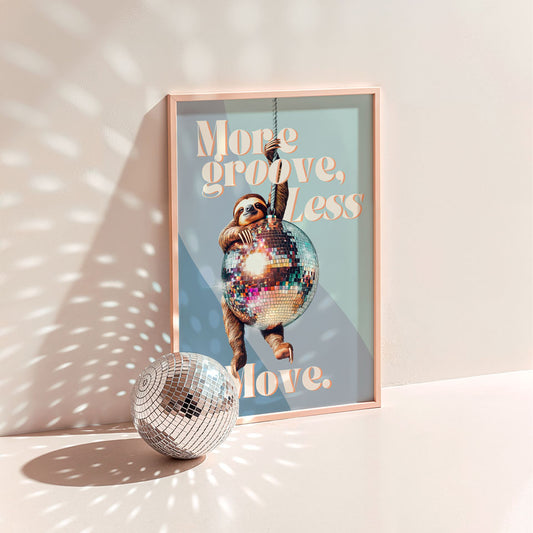 a disco ball sitting next to a poster on a wall