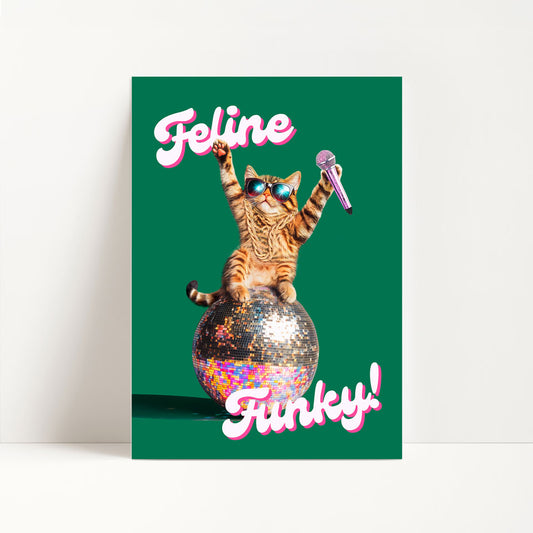 a card with a cat sitting on top of a ball