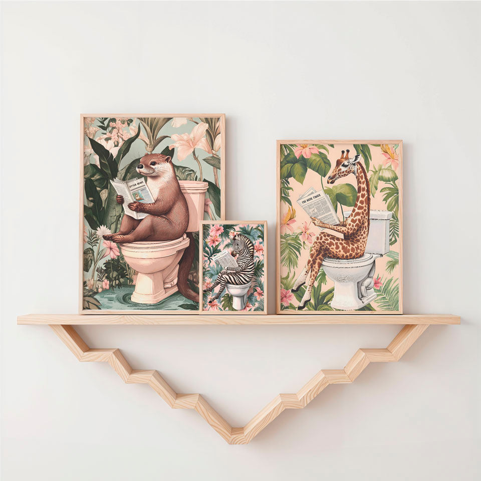 two pictures of animals on a shelf above a toilet